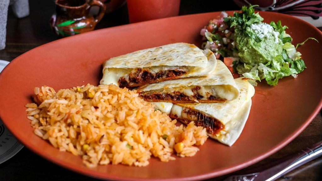 Quesadilla · Quesadilla with Chihuahua cheese and choice of filling. Served with Mexican rice and guacamole.
