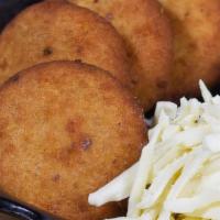 Arepitas Dulces · Fried sweet arepitas made with corn meal, sugarcane and a little touch of anise, served with...