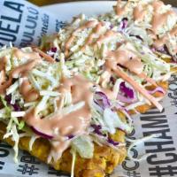 Tostones Margaritenos · Crispy fried Tostones with coleslaw salad served on top with shredded Queso Blanco and pink ...