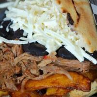 Arepa Pabellon · {shredded beef, fried plantain, black beans and white cheese}