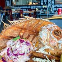 Pescado Frito · Fried fish (Pargo) served with fresh Coleslaw salad and crispy Tostones