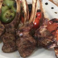 Lamb Chops · Marinated grilled lamb chops. Served with rice, red cabbage salad with grilled tomato & bell...