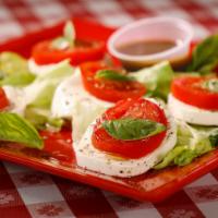 Caprese Salad · Fresh mozzarella cheese, fresh tomatoes, olive oil, fresh basil & balsamic vinegar.