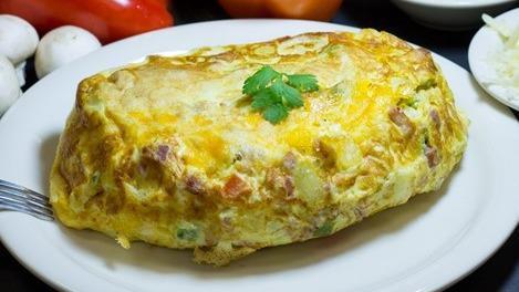 Veggie Omelette · Green and red peppers, onions sauteed with fresh and mushrooms.