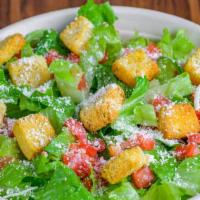Caesar Salad · Crisp romaine lettuce, fresh diced tomatoes, shaved parmesan cheese, served with Caesar dres...