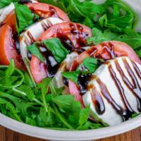 Caprese Salad · Stacks of sliced buffalo mozzarella cheese, fresh sliced tomatoes and basil. Served with hom...