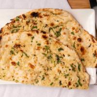 Garlic Naan · Unleavened white bread stuffed with fresh minced garlic and herbs, baked in clay oven.