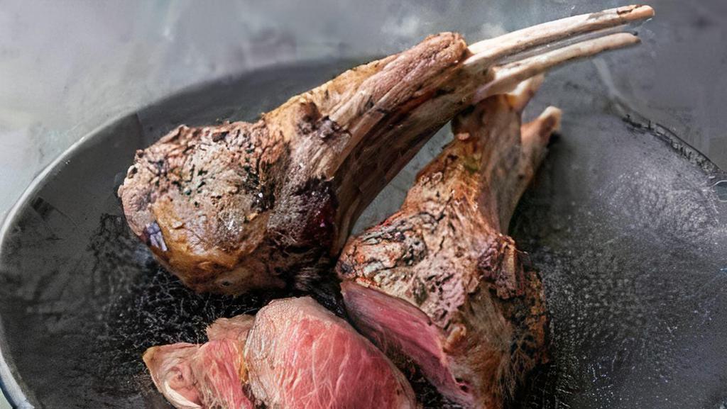 Lamb Chop Lollipops · Pan-seared in garlic herb compound butter, served with seasoned rice, and roasted asparagus.