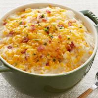 Loaded Smashed Potatoes · Smashed russet potatoes smothered with butter, cheddar cheese, crispy bacon and chives. Serv...