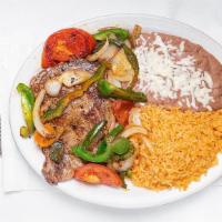 Bistec & Peppers · Rib-eye steak grilled with tomatoes, onions and bell peppers. Served with rice, lettuce, and...