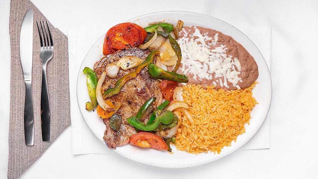 Bistec & Peppers · Rib-eye steak grilled with tomatoes, onions and bell peppers. Served with rice, lettuce, and three tortillas.