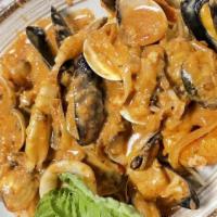 Seafood Combo · Shrimps, clams, baby clams, calamari, mussels, mushrooms and onions in pink sauce over spagh...