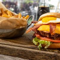 Deluxe Burger · Angus beef burger with ham, cheese, bacon, fried egg, vegetables and sauces.