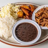 Pabellon Criollo Con Arroz Blanco, Fijoles Negros, Platanos , Carne Mechada, Y Queso Rallado · Shredded beef, white rice, black beans, fried plantains, shredded cheese and petite bread.