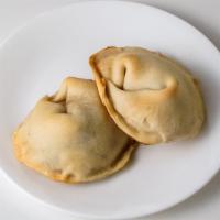 Empanadas Argentina De Pollo Guisado · Argentinan patties stuffed with shredded chicken.