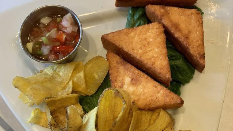 Queso Frito · Deep fried cheese, served with crispy plantain chips, and chile criollo.