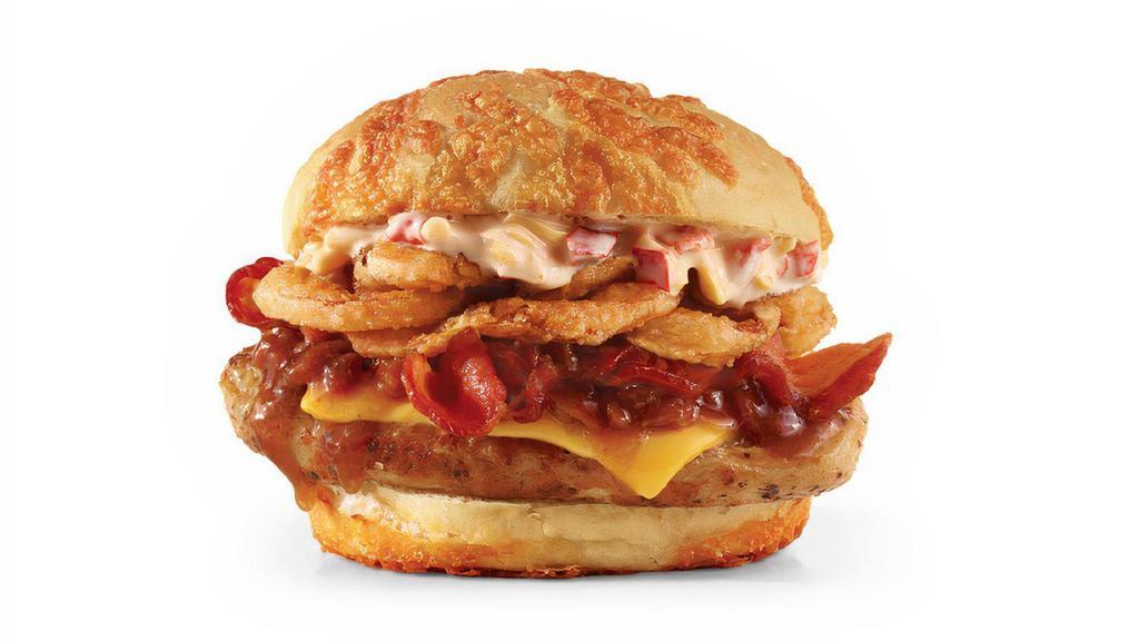 Grilled Big Bacon Cheddar Chicken · An herb-marinated grilled chicken breast covered in creamy cheddar cheese and bacon jam, topped with Applewood smoked bacon, crispy onions, and a slice of American cheese, all on a pillow-soft, toasted cheddar bun. Did we miss anything? Didn’t think so.