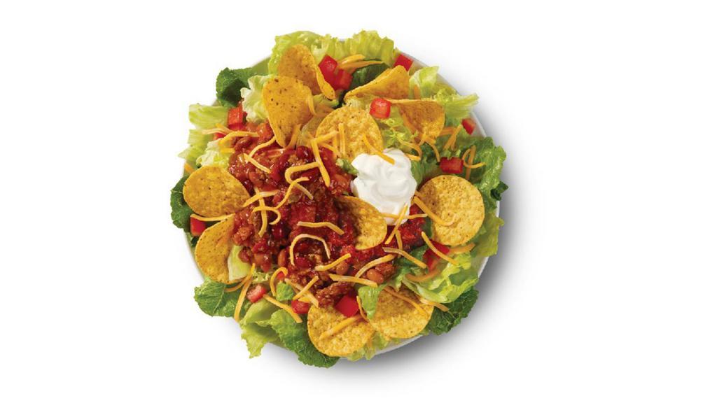 Taco Salad · Made fresh daily with Wendy’s signature lettuce blend, shredded cheddar cheese, diced tomatoes, salsa, sour cream, tortilla chips, and our famous, hearty chili. A fresh take on tacos perfect for Tuesdays, Wednesdays, or any other days for that matter.