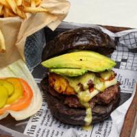 Caribe Burger · JSB beef patty, grilled white cheese, avocado, fried plantain, and our signature honey ginge...