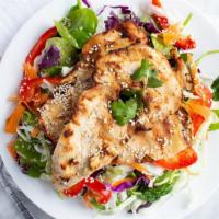 Asian Chicken Salad · Grilled chicken on top of spinach, cabbage, carrots, edamame, sesame seeds, almonds with Ora...