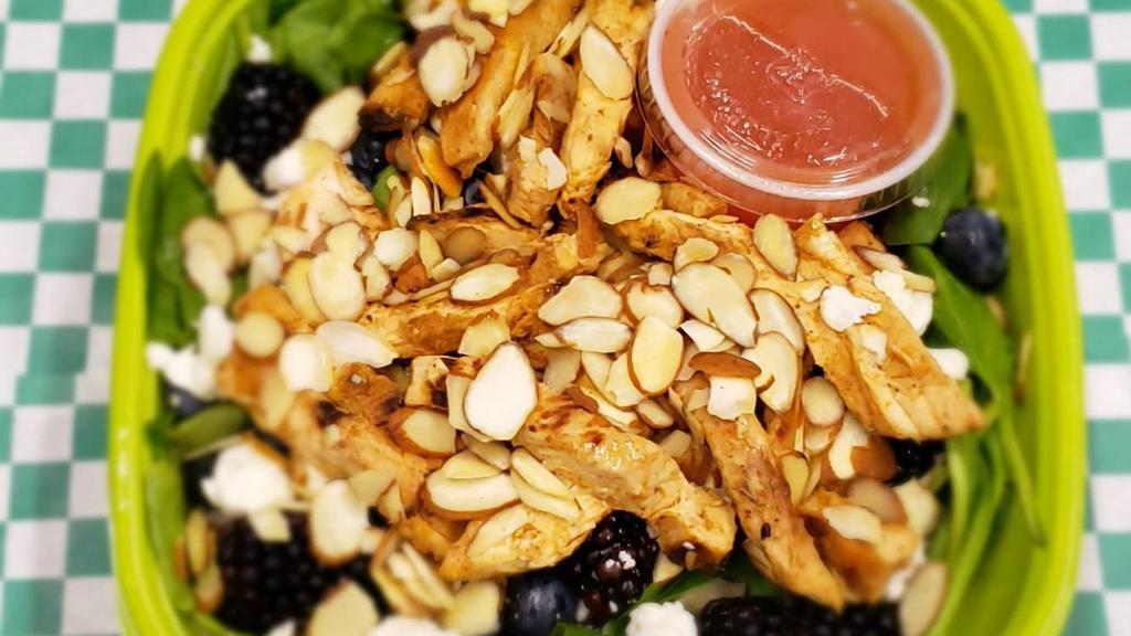 Chicken Spinach Fruit Salad · Grilled chicken and seasonal fruit on top of spinach, walnuts and goat cheese with fruit sweet dressing