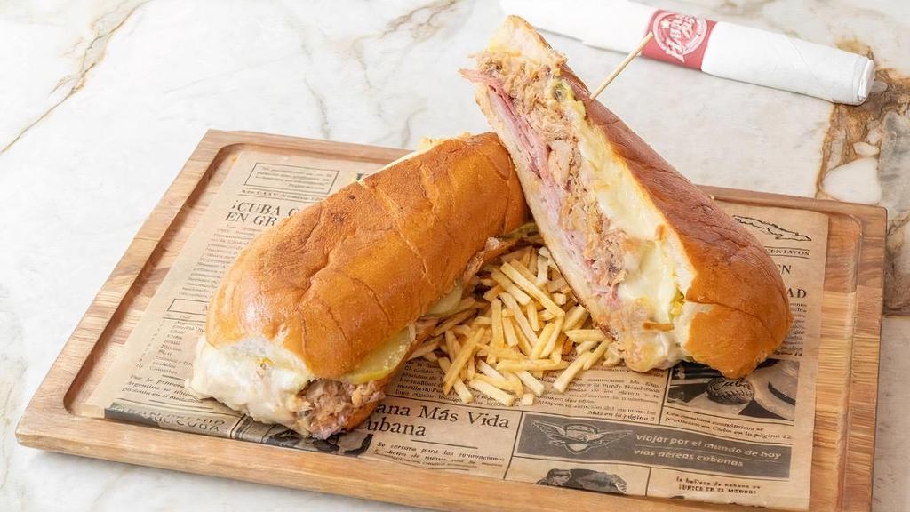 Cubano Sandwich · A Cuban classic served with ham, roasted pork, swiss cheese, pickles, and mustard.. Served in perfectly pressed Cuban bread.