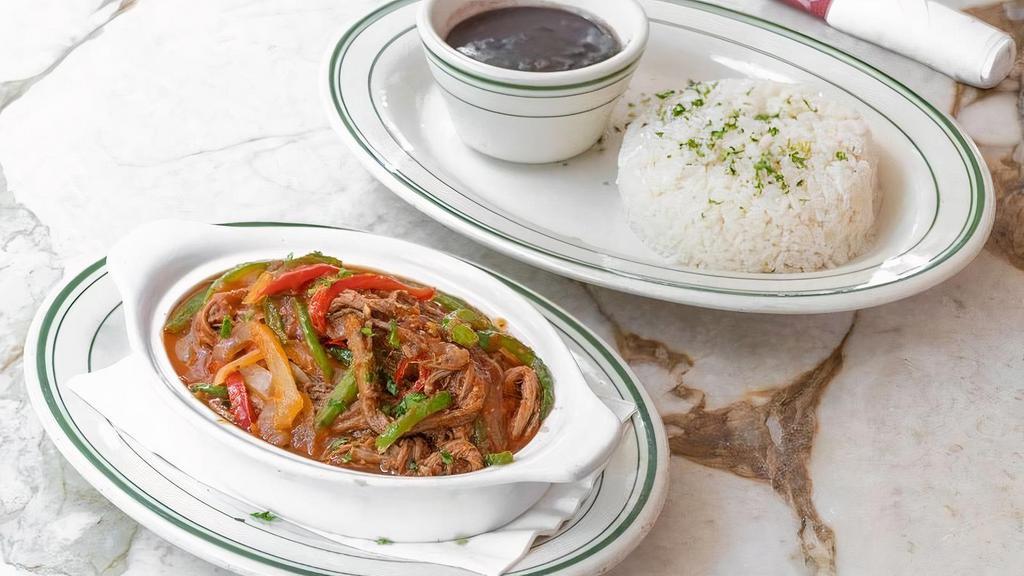 Ropa Vieja · Braised and shredded stewed in criolla sauce. Served with white rice and black beans.