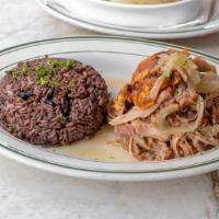 Lechon Asado · Slow oven roasted pork leg with Cuban mojo. Served with moro rice and yuca.