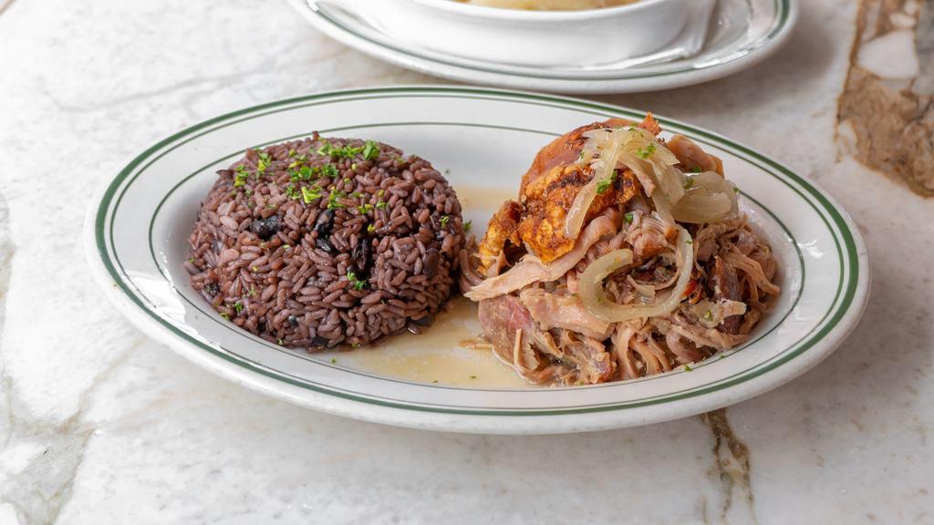 Lechon Asado · Slow oven roasted pork leg with Cuban mojo. Served with moro rice and yuca.