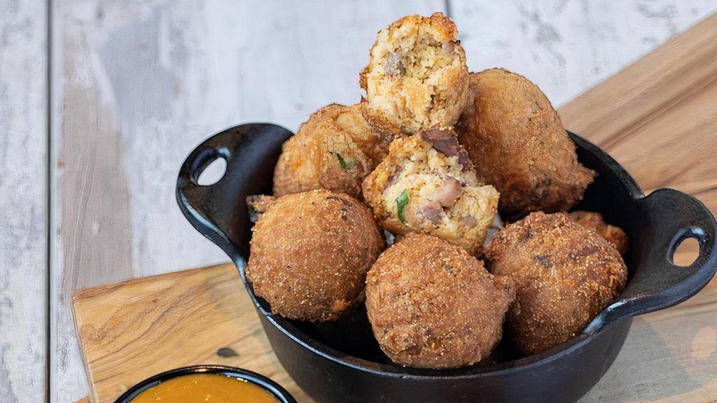 Hush Your Mouth Brisket Hushpuppies · Deep-fried cornbread made with cheddar, green onion and chipotle. Served with a tangy mustard dip.