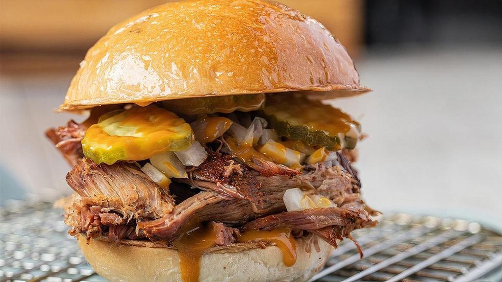 Pulled Perfect Pork · Classic, pulled and chopped pork BBQ on a toasted bun. Served with a side of pickles, onions and jalapenos