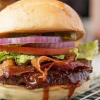 Bbq Bacon Burger · Flamed grilled burger brushed with tangy BBQ sauce, topped with bacon lettuce, tomato, onion...