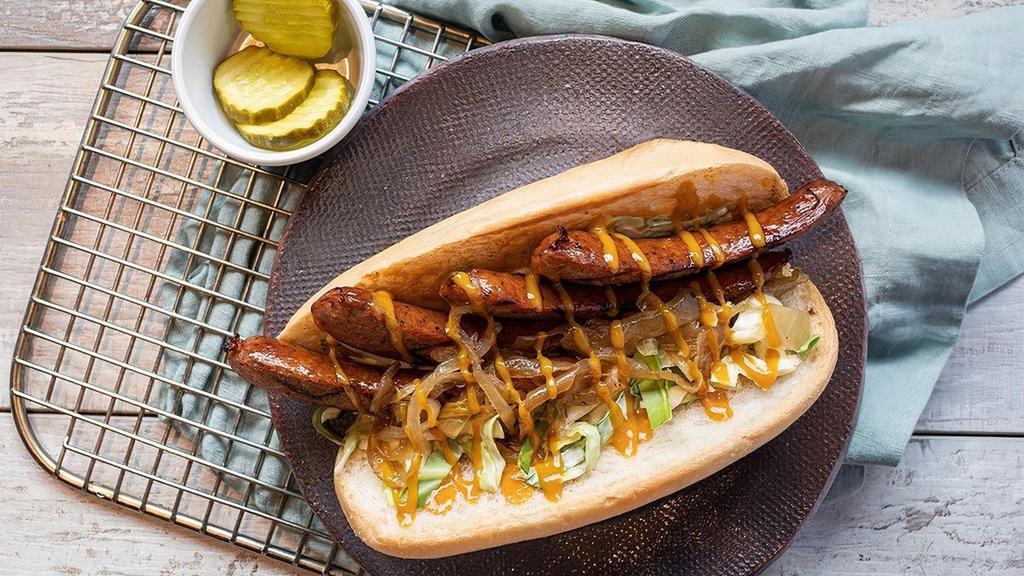Bang Bang Seared Sausage Sandwich · Delicious grilled slabs of sausage with slaw, grilled onions, drizzled mustard sauce and BBQ on a toasted roll. Served with pickle chips.
