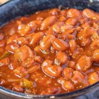 Baked Beans · Ranch style beans baked slow with a skosh of beer, onions, jalapenos and BBQ sauce