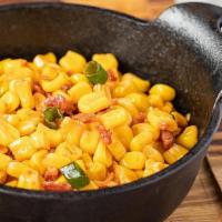 Smokehouse Corn · Cut corn sauteed with bacon, onions and smoked paprika
