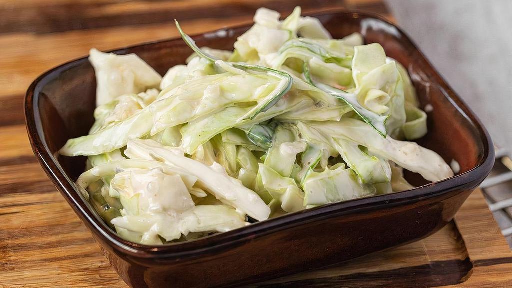 Cole Slaw · Tart and creamy slaw with cut cabbage and onions