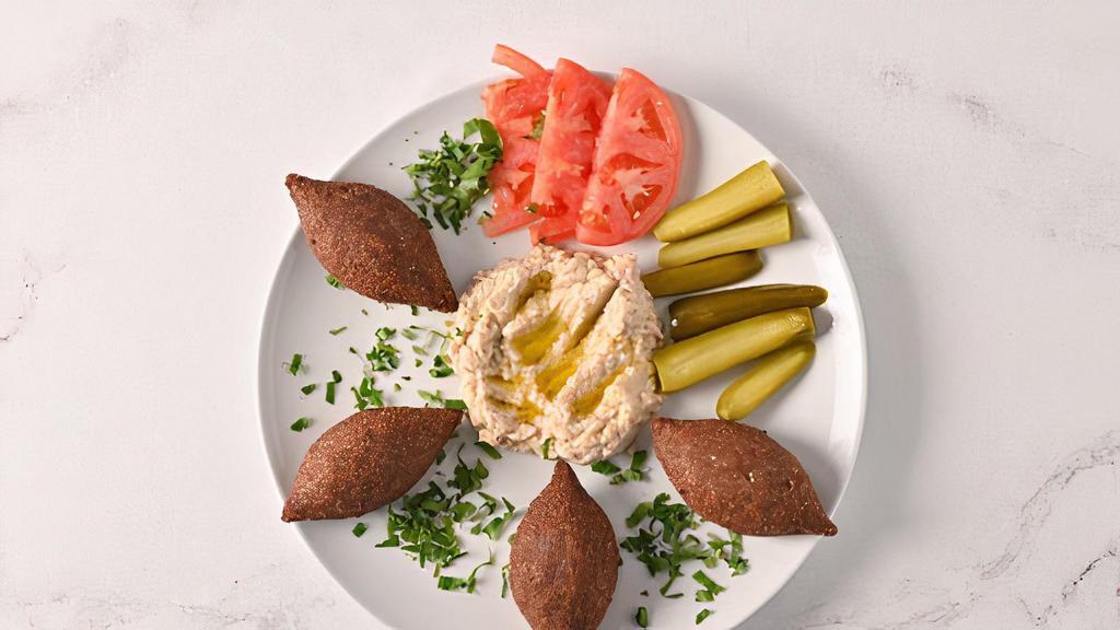 Fried Kibbeh · Little football-shaped meat and wheat shells stuffed with seasoned ground beef.