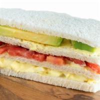 Peruvian Triples · Tomatoes, avocado, eggs and mayonnaise serve on white bread.