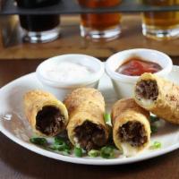 Philly Cheesesteak Egg Rolls · fried onions, american cheese, ketchup, horseradish sauce