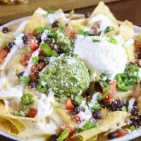 Nachos · pico de gallo, seasoned black beans, green onion, serrano peppers, mexican crema, sour cream...