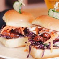 Crispy Pork Belly Sliders · red cabbage slaw, pickled daikon & carrots, korean bbq sauce, sriracha mayo, potato rolls