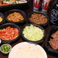 Tacos · seasoned ground beef, chicken tinga, flour tortillas, sour cream, cilantro, lettuce, shredde...