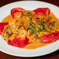 Crab Ravioli · Baby shrimp, diced tomatoes, mushrooms spinach & lobster sauce.