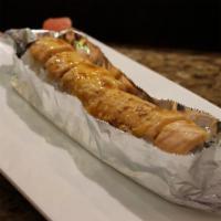 Nobody'S Home Roll · Salmon on top of a California roll, baked w. spicy mayo and eel sauce