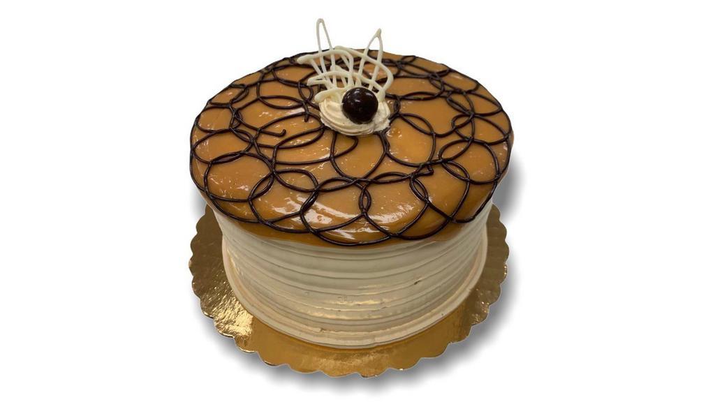 Dulce De Leche · This delicious sponge cake is filled and iced with Dulce de Leche Mousse decorated with Dulce de leche.
and ganache