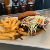 Bbq Pulled Pork Sandwich · Slow Cooked in a Tangy BBQ Sauce, Topped with Coleslaw, Pickles. Served in a Toasted Sesame ...