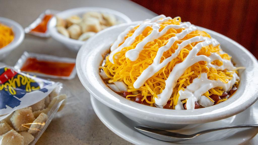 Loaded Chili Bowl · Our secret-recipe chili with beans and onions topped with shredded cheddar cheese and sour cream.