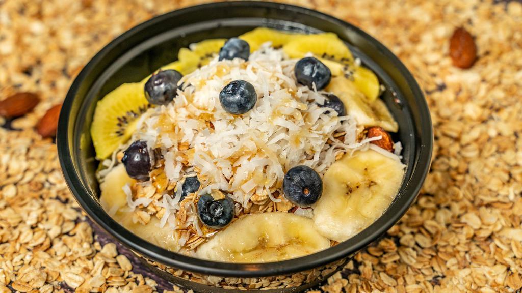 Signature Açai Bowl · Organic açai, banana, blueberry, kiwi, vanilla and almond granola, coconut flakes, organic honey. Additional fruits or toppings for additional charge.