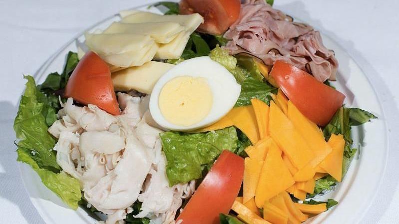 Chef Salad · Romaine lettuce, tomatoes, ham, turkey, cheddar, provolone, and a hard boiled egg.