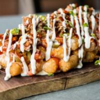 Pork Totcho · tater tot mountain with bbq pulled pork, pico de gallo, jalapenos, cheddar cheese, white que...